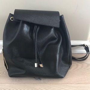 Black backpack with brass detailing